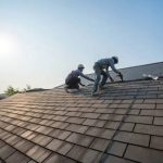 Professional roofing contractors replacing an asphalt shingle roof during ideal weather conditions in Port Angeles, Washington.
