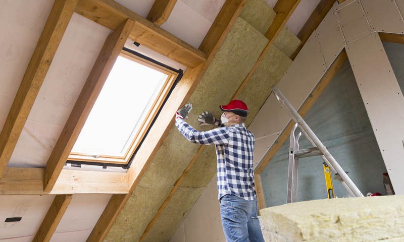 Contractor installing attic insulation and roof ventilation system in Port Angeles Washington